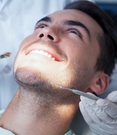 man receiving cosmetic dental care at Uptown Family Dental