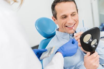 man choosing which color he wants his dental veneers to be