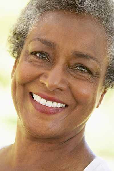 woman smiling with her new dentures from Uptown Family Dental