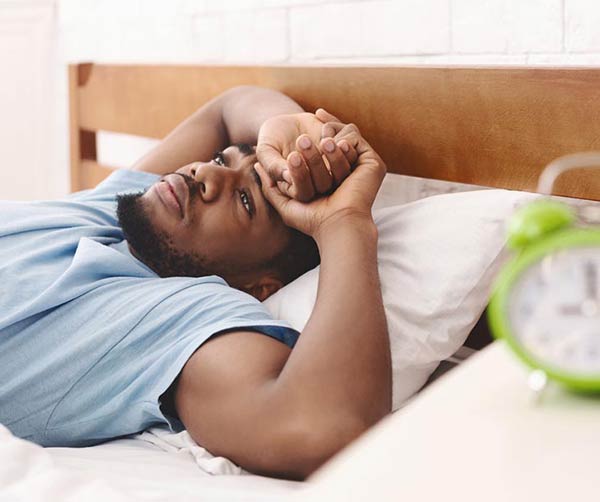man awake at night due to sleep apnea