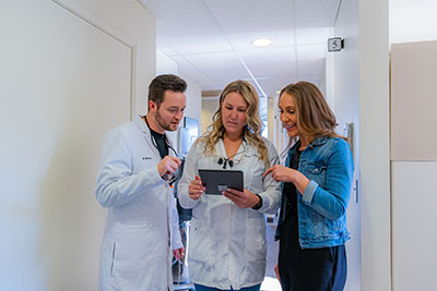 The friendly staff at uptown family dental discussing oral surgery options together. 